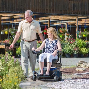 Woman using power wheelchair outdoors